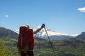 Happy woman traveler with open arms stands on the mountain plate Royalty Free Stock Photo