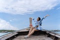 Happy woman traveler relaxing on boat enjoying tropical beach scenery, travel destinations. Travel Phuket in Thailand Royalty Free Stock Photo