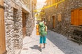 Woman traveler walking by pilgrim route in highland ancient village in Pyrenees mountains, Spain Royalty Free Stock Photo
