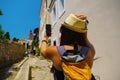 Happy woman traveler is walking and taking selfie photo on phone on Greek island of Rhodes, Dodecanese, Greece Royalty Free Stock Photo