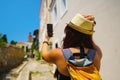 Happy woman traveler is walking and taking selfie photo on phone on Greek island of Rhodes, Dodecanese, Greece Royalty Free Stock Photo