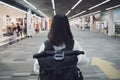 Happy woman traveling and walking in airport. Girl in hat with backpack traveling in the airport Royalty Free Stock Photo