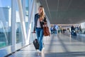 Happy woman travelling and walking in airport Royalty Free Stock Photo