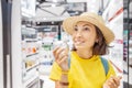 Woman tries new perfume fragrances in perfume shop