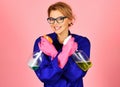 Happy woman in uniform and rubber gloves with cleaning spray. Professional cleaning service. Royalty Free Stock Photo