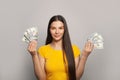 Happy woman with US dollars money. Pretty female model holding American dollars 100 banknote in her hands portrait Royalty Free Stock Photo