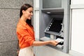 Happy Woman Using ATM Machine Withdrawing Dollar Cash Outdoots Royalty Free Stock Photo