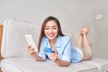 Happy woman using digital tablet for online shopping with credit card in the living room Royalty Free Stock Photo