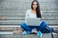 Happy woman using laptop computer outdoors Royalty Free Stock Photo