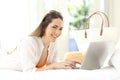 Woman using a laptop looking at you on vacations Royalty Free Stock Photo