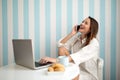 Happy woman using laptop and phone Royalty Free Stock Photo