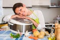 Happy woman using slo-cooker