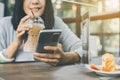 Happy woman using smart phone and connect free internet in cafe