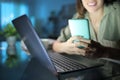 Happy woman using smart phone and laptop in the night Royalty Free Stock Photo
