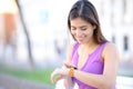 Happy woman using smartwatch in the street Royalty Free Stock Photo
