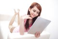 Happy woman using tablet pc on sofa Royalty Free Stock Photo