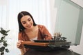 Happy woman using turntable at home