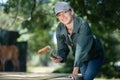 happy woman varnishing park benches