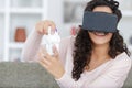 happy woman with virtual reality headset and joystick