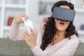 happy woman with virtual reality headset and joystick