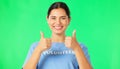 Happy woman, volunteer and hands in thumbs up on green screen for agreement or success against a studio background Royalty Free Stock Photo