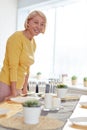 Happy woman waiting for friends at dinner party