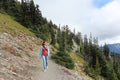 Happy woman walking along a mountain trail near Mount Rainier,  USA Royalty Free Stock Photo