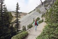 Happy woman walking along a mountain trail near Mount Rainier, Washington State Royalty Free Stock Photo