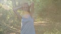 Happy woman walking on the green forest