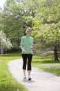 Happy woman walking with MP3 player Royalty Free Stock Photo