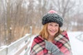 Woman bundled up in hat and scarf outside while snowing Royalty Free Stock Photo