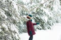 Happy woman walking through a snowy forest