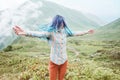 Happy woman walking in summer mountains.