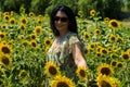 Happy woman walking in sunflowers field Royalty Free Stock Photo