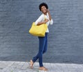 Happy woman walking and talking on mobile phone Royalty Free Stock Photo