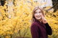 Happy woman walking and talking on mobile phone in park Royalty Free Stock Photo