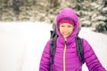 Happy woman walking in winter forest with backpack Royalty Free Stock Photo