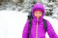 Happy woman walking in winter forest with backpack Royalty Free Stock Photo