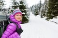 Happy woman walking in winter forest with backpack Royalty Free Stock Photo