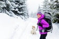 Happy woman walking in winter forest with dog Royalty Free Stock Photo