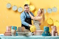 Happy woman washing her husband`s face with dishwashing liquid