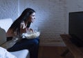 Happy woman watching television at sofa couch happy excited enjoying eating popcorn Royalty Free Stock Photo