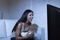 Happy woman watching television at sofa couch happy excited enjoying eating popcorn Royalty Free Stock Photo