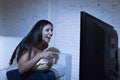 Happy woman watching television at sofa couch happy excited enjoying eating popcorn Royalty Free Stock Photo