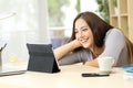 Happy woman watching video content on tablet