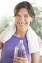 Happy Woman With Water Bottle And Towel Around Neck Royalty Free Stock Photo