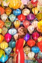 happy woman wearing Ao Dai Vietnamese dress with colorful lanterns, traveler sightseeing at Hoi An ancient town in central Vietnam Royalty Free Stock Photo