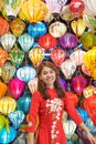 happy woman wearing Ao Dai Vietnamese dress with colorful lanterns, traveler sightseeing at Hoi An ancient town in central Vietnam Royalty Free Stock Photo