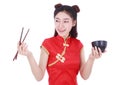 Woman wearing chinese cheongsam dress with chopsticks and bowl i Royalty Free Stock Photo