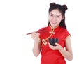Woman wearing chinese cheongsam dress with chopsticks and bowl i Royalty Free Stock Photo